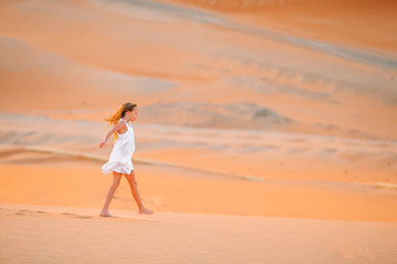 Girl among dunes in Rub al-Khali desert in United Arab Emirates
