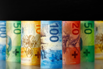 Rolled-up and laid-up Swiss banknotes