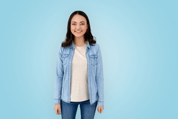 Young adult asian woman standing against grey background