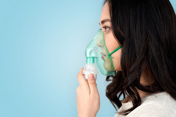 Young adult asian woman with oxygen mask