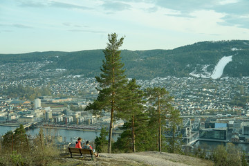 People back sitting on the bench and watching the scenery view in Drammen city, Norway.