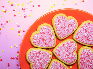 Obraz na płótnie Canvas Some sweet cookies with heart shape in a orange plate