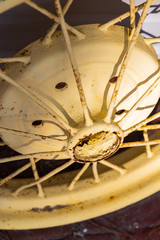 Yellow old car wheel and rusty spokes close-up