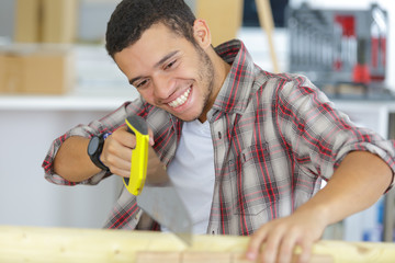 portrait of man holding a handsaw