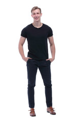 Fototapeta premium in full growth. confident guy with his hands in his pockets