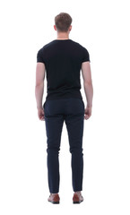 Fototapeta premium rear view. young man looking at white wall