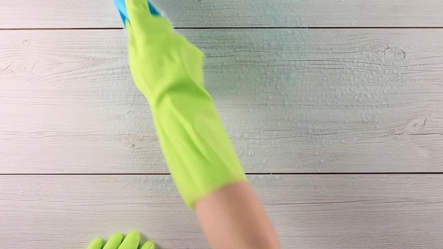 Close-up Of Maid Wearing Gloves Cleaning Floor