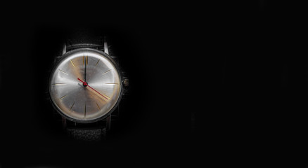 Beautiful Watch with white dial on a black background and red clock hands showing 12 o'clock