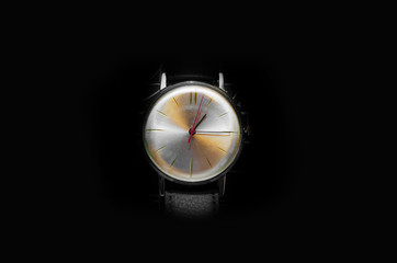 Beautiful Watch with white dial on a black background and red clock hands showing 1 o'clock