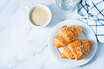 Fresh croissants with berries and cup of coffee