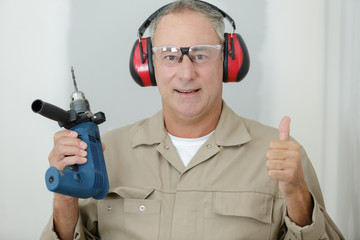 happy man holds a drill