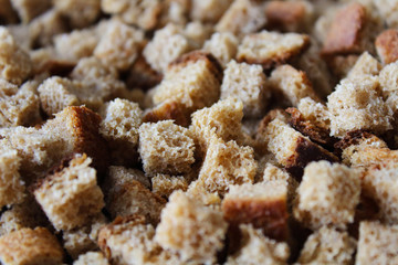 Fresh small square bread crumbs. Close-up. Background. Texture.