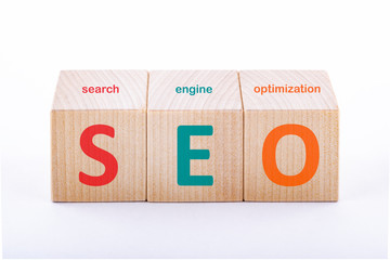 SEO concept. Search engine optimization text on wooden cubes on a white background.