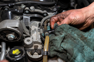 The mechanic bleeds the fuel system with a pump that is on the fuel line, after installing a new...