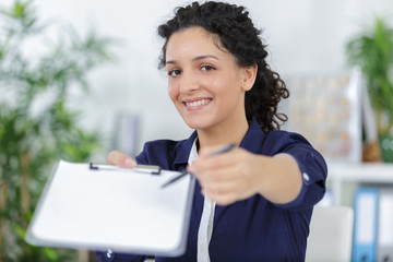 happy businesswoman asking for a signature