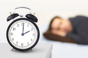 Daylight Saving Time, Spring forward. A clock watch with person sleeping in the background.