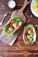 Mexican tacos with vegetables and falafel.