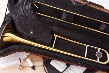 Student trombone and equipment on wooden table