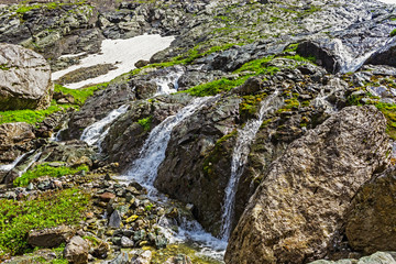 fast mountain stream with a waterfall closeup