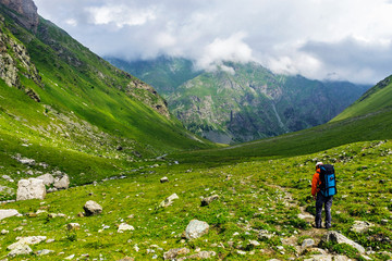 tourist with backpack travel in the caucasus mountains