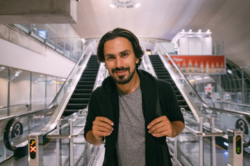 A man near the escalator at the airport