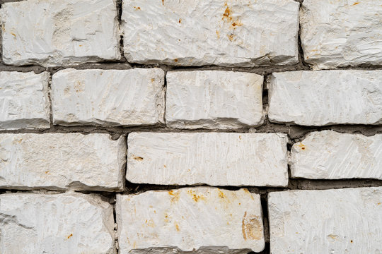 Texture Of Old Sandstone Brick Wall. Foundation Of An Ancient Village House