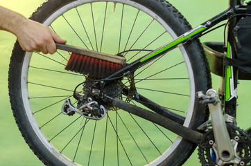 Washing the bike in the workshop. Brush in hand mechanic