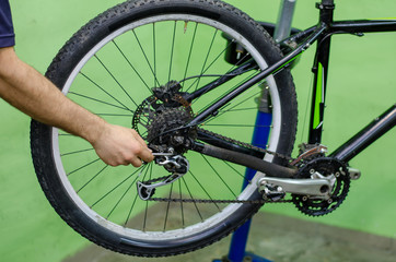 Bicycle repair, mechanic in the workshop. Modern mountain bike.