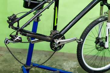 bicycle repair. mountain bike in the workshop. Rear derailleur adjustment