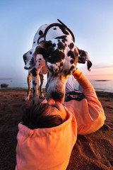 Thoughtful female owner with dog on coastline