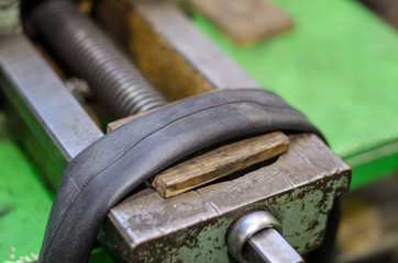 Repairing bicycle tube In workshop. Close up image of glue to repair inner tube of bicycle wheel. The mechanic does his job thoroughly.