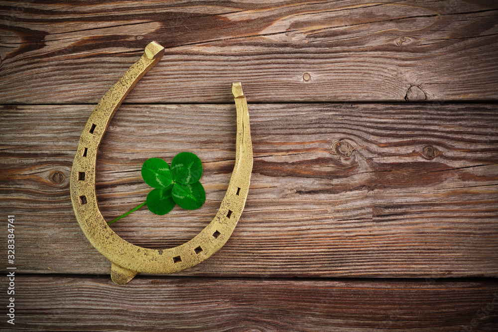 Wall mural Vintage clover on wooden background, great design for any purposes. Saint patrick day. Four leaf clover.