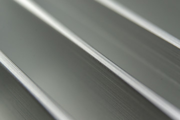 Symetric Close-up industrial realistic silver aluminum extrusion heatsink fins after industrial CNC routing processing