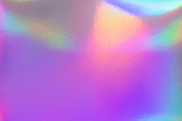 Abstract trendy rainbow holographic background in 80s style. Blurred texture in violet, pink and...