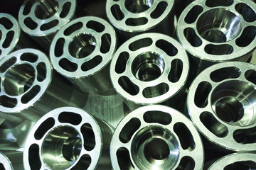 A series of machined shiny metallic parts with selective focus. High-tech part processing. Abstract tech background.