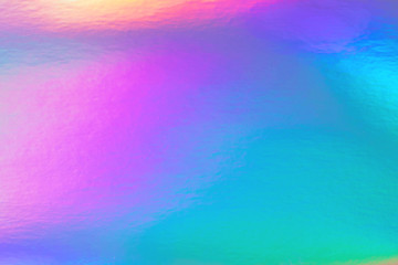 Abstract trendy rainbow holographic background in 80s style. Blurred texture in violet, pink and...