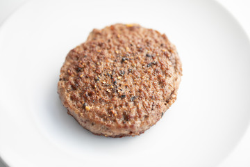 Close up of tasty beef patty on a white plate