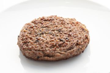 Close up of tasty beef patty on a white plate