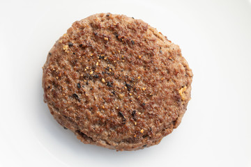 Close up of tasty beef patty on a white plate