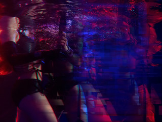 Cyberpunk style portrait of beautiful young girls poses underwater. Picture has noir tones