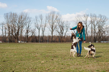 Obraz na płótnie Canvas Girl Enjoying Beautiful Day Outdoor With Her Dogs