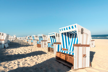 Beach chairs in a row on Sylt island. Sea beach on sunny day