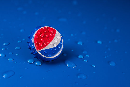 Dubai, UNITED ARAB EMIRATES - February 20, 2020: classic cap close-up of Pepsia-Cola on a blue background with drops of water