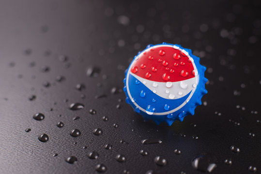 Dubai, UNITED ARAB EMIRATES - February 20, 2020: classic cap close-up of Pepsia-Cola on a black background with drops of water