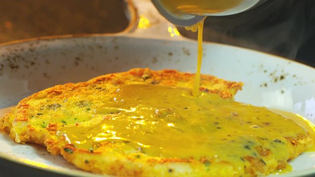 Add Sauce To The Dish In Pan Chicken Schnitzel. Close-Up Food. Cooking Process. Chef Cooking Dish. Chef Preparing  Food. (Red Dragon Camera, Cinematic Quality Macro Footage).