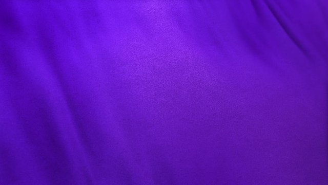 purple flag cloth in full frame with selective focus. Seamlessly looping 3D animation of violet lavender colored garment with clean natural linen texture for background banner or wallpaper use.