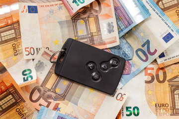 Karta do samochodu leży na banknotach Euro o nominałach 20 i 50 Euro.