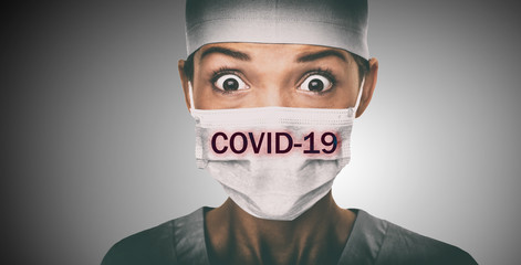 Covid-19 coronavirus text written over doctor surgical face mask Asian woman hospital worked scared shocked by Corona virus pandemic worried. Title on background.