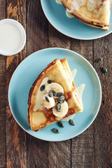 Thin pancakes with bananas and condensed milk.
