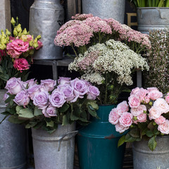 A variety of colors near the Liberty store in London. Large bouquets in tin vases. Pink roses